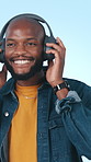 Headphones, dance and black man in studio with music for positivity, good mood and relax on weekend. Happy, streaming and person listening to audio, radio and playlist for energy on blue background