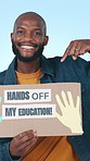 Face, black man and poster for protest, pointing and hands off my education on blue studio background. African person, gesture or cardboard for rally, equality and volunteer for justice or university