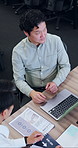 Above, business and Asian people in meeting with documents for finance review, proposal and strategy. Corporate, talking and workers on laptop for financial portfolio, research and budget planning