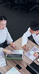 Laptop, business and above of Asian people in meeting with documents for finance review, proposal and strategy. Corporate, teamwork and workers for financial portfolio, research and budget planning
