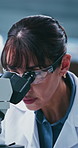Medical, goggles or scientist in lab with microscope, test or examination in vaccine development. Science, glasses or woman in clinic with equipment, research or investigation in pharmaceutical trial