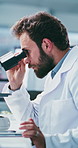 Tablet, science or man with microscope in lab, medical testing or experiment info for breakthrough. Cure development, medicine study or scientist typing for observation notes, pharma research or tech