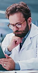 Man, scientist and reading with tablet in lab for research, test results and experiment. Thinking, male person and tech for medical trial, healthcare study and problem solving for vaccine development