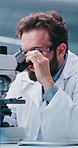 Scientist, man and research in lab with microscope, experiment or test sample for medical innovation. Person, science investigation and healthcare trial in clinic with goggles, biotech or inspection.