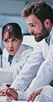 Scientist, people or computer with discussion in lab for clinical trial, medical results or innovation. Biotech, team or tech with feedback for cancer research, vaccine development or method planning