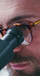 Study, microscope and glasses with man in laboratory for vaccine research, disease cure and closeup. Medical innovation, science and experiment with person for healthcare discovery and biotechnology