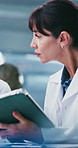 Woman, scientist and meeting with tablet in lab for research, test results and experiment report. Team, talking and digital for medical trial, healthcare study and information for vaccine development