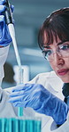Scientist, study and woman with test tube in lab, biotech and medical research for drug development. Clinic, ppe and mature person with eyewear for safety, pharmaceutical and innovation with pipette