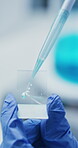 Hands, scientist and liquid on microscopic slide for medical research, preserve specimen and innovation. Gloves, person and wet mount with pipette in lab for sample fixation, clinical trial and study