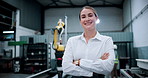 Woman, face and arms crossed at warehouse for robotics with smile, pride and futuristic engineering. Person, happy and technician in portrait for automated machine, confidence and career in Germany