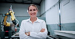 Woman, face and arms crossed at factory for robotics with smile, pride and futuristic engineering career. Person, happy and technician in portrait, machine learning and job at warehouse in Germany