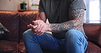 Hands, therapy and man with anxiety on sofa for trauma, stress or guidance in office appointment. Psychology, counseling session and nervous patient with mental health crisis, worry or rehabilitation