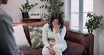 Talk, therapy and woman with stress on sofa for trauma, anxiety or guidance in office appointment. Psychologist, counseling session or person with depression, mental health crisis or rehabilitation