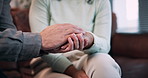 Holding hands, support and couple on sofa in home with comfort, love and bonding together. Empathy, care and man with woman for connection with compassion, marriage or trust in living room at house.