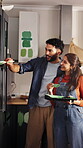 Happy, couple and painting cupboard in kitchen for home upgrade, renovation or planning together. Interior design, people and hug with paintbrush for DIY makeover, house improvement and decor support