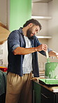 Phone call, painting and man in kitchen at house for renovation, repairs or maintenance on weekend. Cellphone, homeowner and male person on mobile conversation with DIY makeover at apartment.
