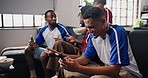 Friends, watching tv or man with mobile in house, soccer stats research or sports betting addiction. Distraction, typing or happy fans with football match broadcast, phone or attention for tournament