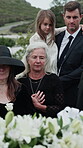 Death, grief and family at funeral in cemetery, mourning together and view casket for remembrance. Face, memorial service and sad people with gathering for burial ceremony, farewell ritual and loss