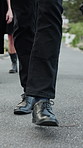 Legs, people and walking at cemetery for funeral procession, mourning and loss at ceremony. Feet, shoes and group for steps on ground, outdoor or grief at graveyard with farewell, support and death