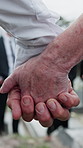 Holding hands, funeral or people in cemetery with care, support or remembrance with mourning. Emotional, loss or family in graveyard with burial, comfort or shared grief at memorial service.
