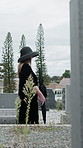 Family, people and walking at cemetery for funeral procession, mourning and loss at ceremony. Men, women and group with bereavement, outdoor or grief at graveyard with farewell, support and death