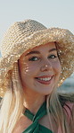 Beach, face and woman with hat on holiday, tourist and confident on adventure in nature and tourism. Ocean, break and person on summer vacation, outdoor and happy for peaceful getaway in Denmark