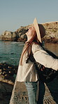 Backpacking, happiness or woman at ocean with arms raised, achievement or success in exploration goal. Adventure, freedom or tourist with victory, gratitude or celebration in travel milestone.
