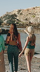 Women, friends and back in harbor with travel on holiday, view and sunset with sightseeing trip. People, group and outdoor in port town for discussion, tourism or direction with ocean on vacation