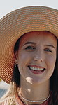 Woman, face and vacation in nature with hat, tourist and sightseeing with weekend for beach getaway. Female person, relax and portrait by ocean with smile, travel adventure and island exploration