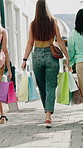 Women, friends and walk in city with shopping bag for retail therapy, sale and tourism with back in road. People, group and outdoor in urban town with package, 