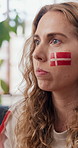Woman, popcorn and watching tv in home with sports, broadcast and football game for entertainment. Female person, eating snack and live stream in house with soccer world cup, contest or Denmark flag.