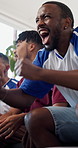 Friends, cheering and watching tv in home with sport competition, team goal and bonding together. Excited people, celebration and football broadcast in lounge with win, handshake or social gathering.