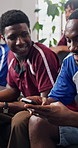 Friends, phone and watching tv in home with football match, social media distraction and men bonding. Happy people,  text message and soccer broadcast in lounge with chat, entertainment and hangout.