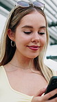 Phone, happy and woman outdoor with texting, networking or chatting on mobile app for communication. Technology, smile and female person with cellphone for contact, connectivity or social media.