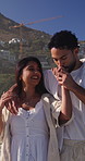 Outdoor, kiss and happy couple with conversation for walk, funny discussion and romantic gesture for date. Affection, talking or people with support for healthy relationship, bonding or laugh at joke