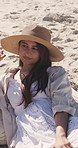 Relax, woman and vacation on beach with hat, tourist sightseeing or reflection for getaway. Female person, summer and thinking by ocean with smile, travel accessory and tropical island for holiday