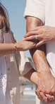 Beach, walking and couple holding hands for holiday, romantic summer trip and getaway for bonding. Outdoor, love and people with support for healthy relationship, travel vacation and explore together