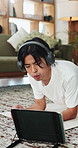 Breathing, fitness and tablet with Asian man in home living room for core strength or training. App, headphones and plank with person on floor in apartment for exercise, health or wellness activity