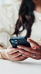 Woman, hands and typing in creative agency with phone, online and post for social media marketing. Female person, browse or email in office with tech, creativity or mobile app for digital advertising