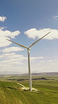Green, wind turbine and renewable energy in environment, drone or sustainability with zero emissions. Grass field, windmill and natural resource for carbon footprint in countryside, space and outdoor