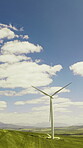 Outdoor, wind turbine and renewable energy for sustainability, drone and eco friendly in countryside. Grass field, windmill and natural resource with zero emissions in environment, space and nature