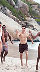 Happy people, friends and running with fireworks on beach for new year or social celebration. Excited, group or playing with smile or sparklers on ocean coast together for festive activity in nature