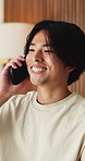 Happy, phone call and Asian man in home talking for social networking, online chat and connection. Weekend, laugh and person on smartphone for communication, contact and conversation in living room