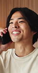 Hello, phone call and Asian man in home talking for social networking, online chat and connection. Weekend, happy and person on smartphone for communication, contact and conversation in living room