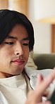Tablet, calm and man in home with networking, texting or chatting on app with relax in living room. Digital technology, research and male person with online website for blog in lounge at apartment.
