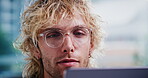 Creative, online and businessman with laptop in office, proofreading and editing article on website. Magazine editor, glasses and person with tech for media publication, vision or review in newsroom