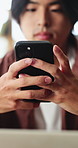 Asian man, hands and typing with phone in home for social media, connection or network. Male person, user or texting with mobile smartphone or app for online chatting, communication or post in house