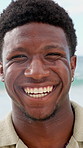 Face, beach and black man laugh on holiday, summer vacation and smile on tropical island. Portrait, funny and African person by ocean for travel, tourism and outdoor adventure with trip in Nigeria
