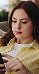 Reading, scroll and woman on sofa with phone for internet, social media and chat on weekend. Home, apartment and person on smartphone for connection, notification and text message on mobile app