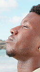 Thinking, peace or black man at ocean with fresh air, travel memory or mindfulness on summer break. Tranquil, closeup or tourist with breathing, vacation mindset or calm perspective on beach getaway.
